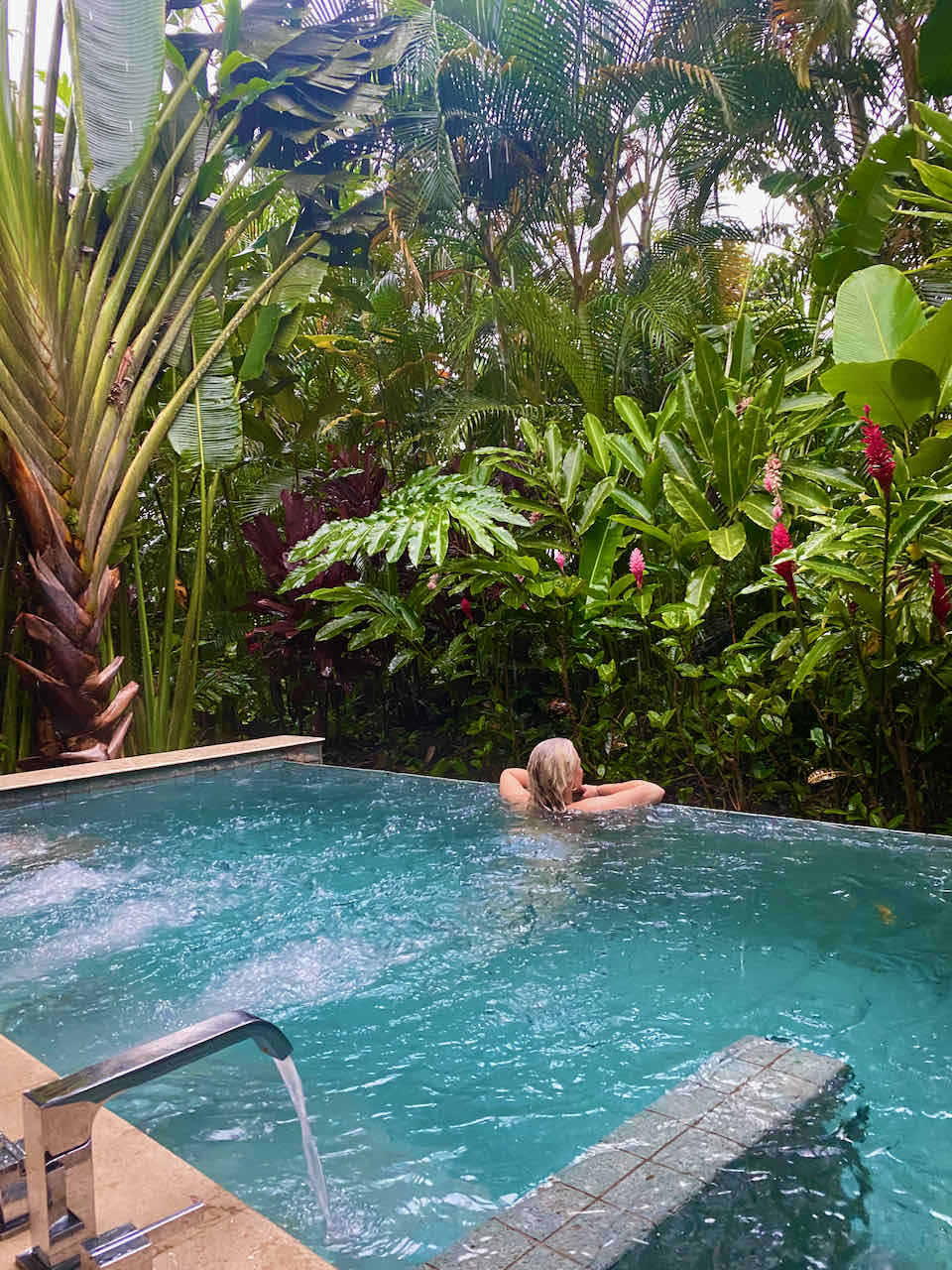 Girl in private plunge pool at a luxury villa in Nayara Springs Resort in Costa Rica. 