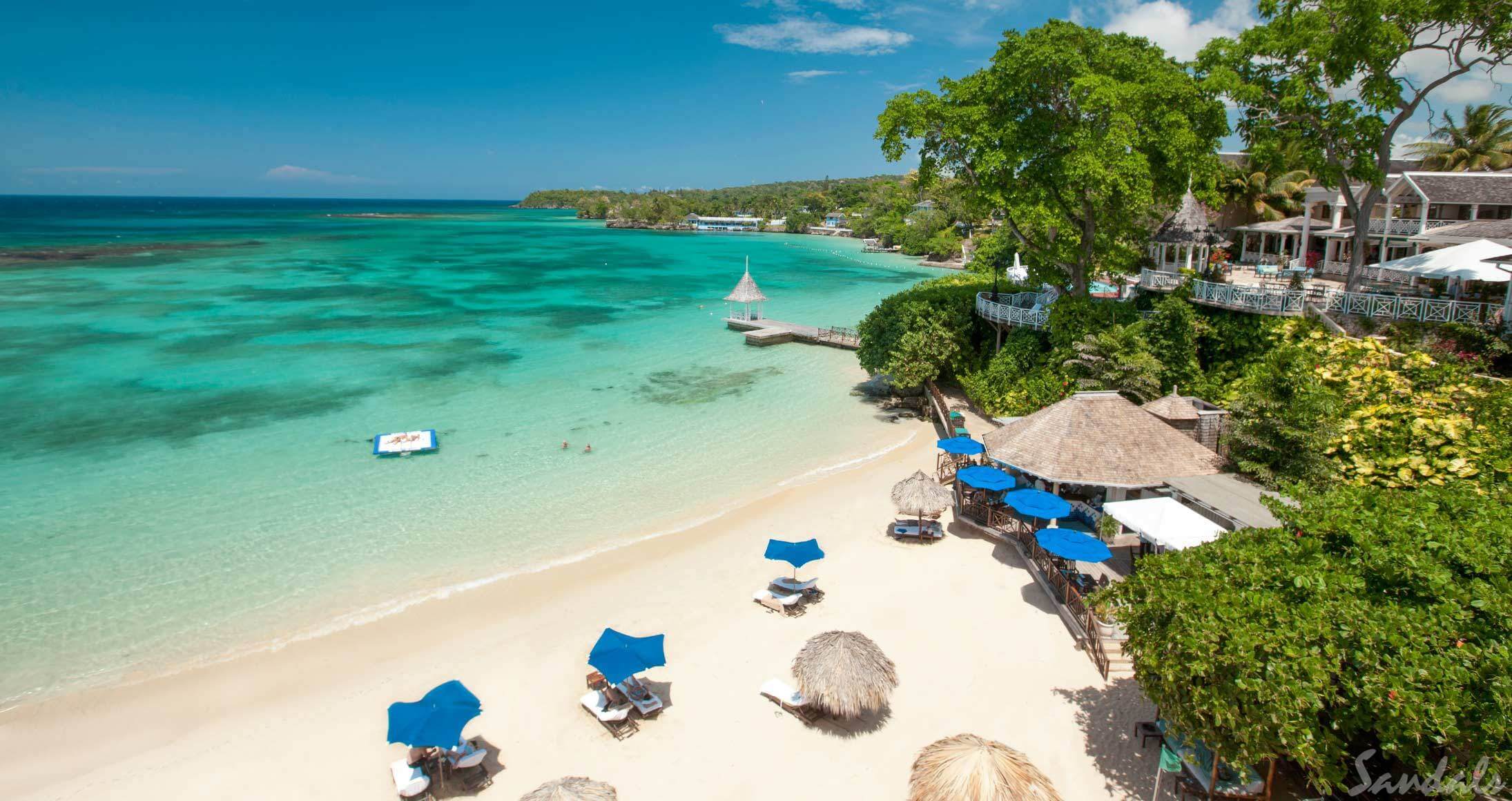 White sand beach with clear water in Jamaica at Sandals Royal Plantation.