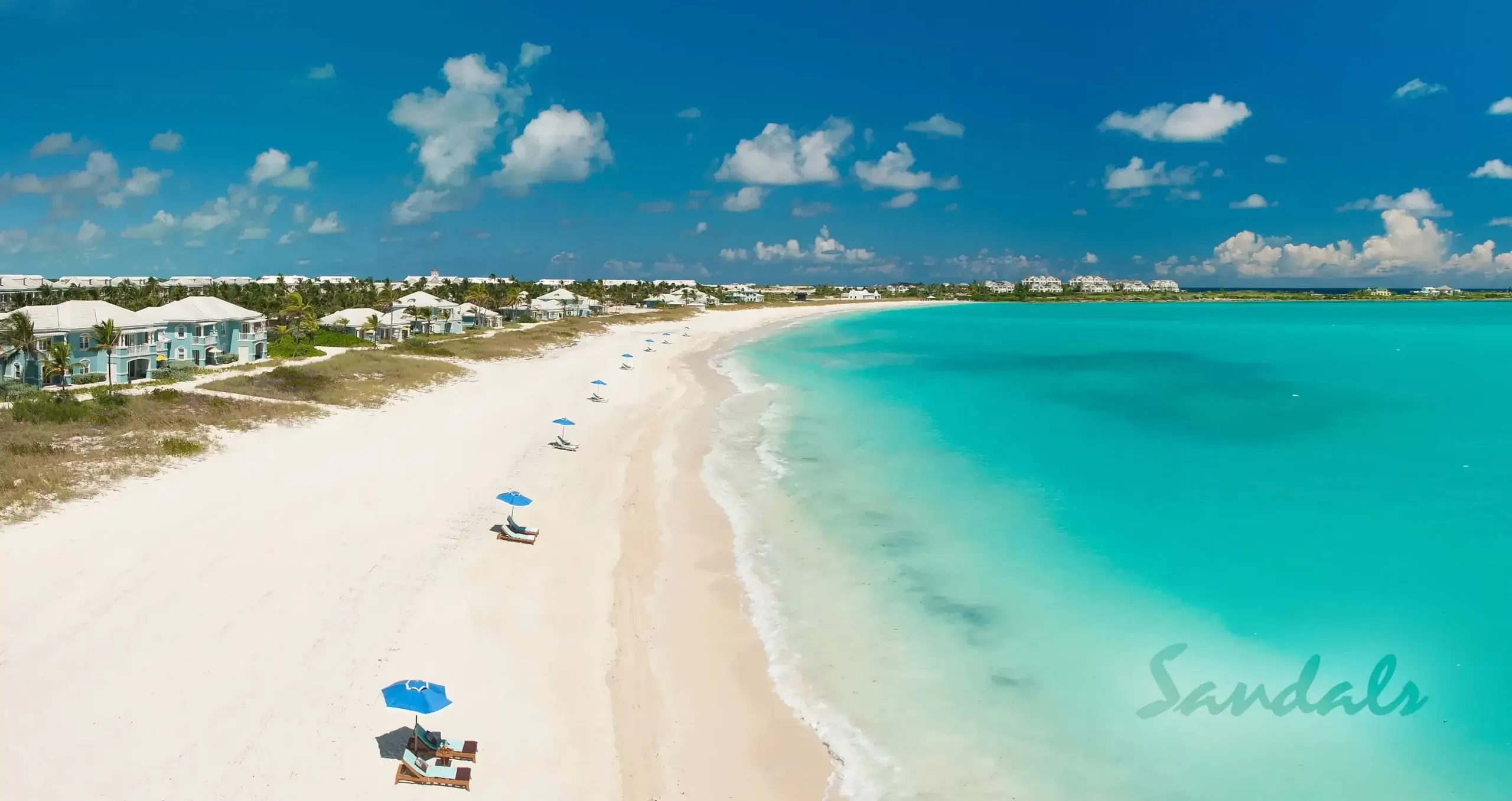 Sandals Emerald Bay in Bahamas white sand beach with clear blue water. 